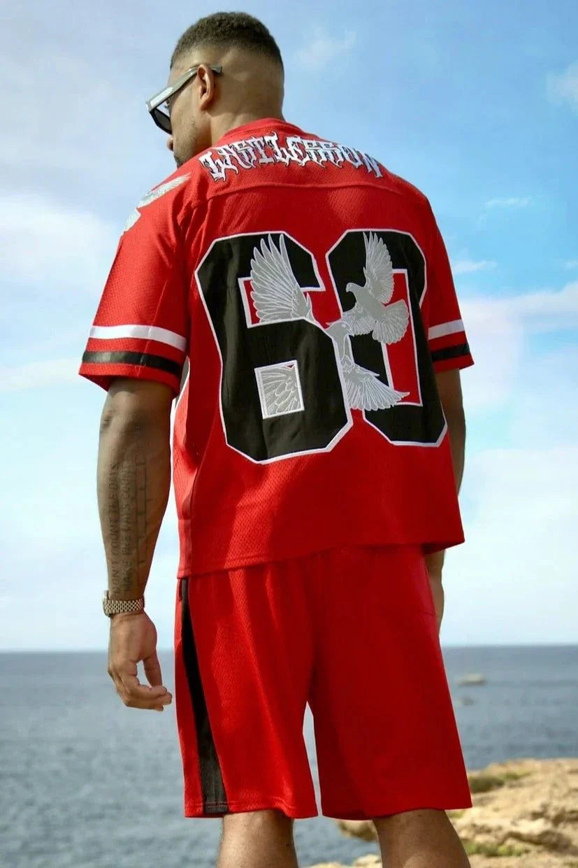 Man wearing red Last Lesson Eagle Jersey with number 63 on back by the ocean