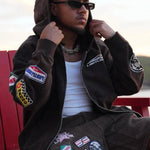 Man wearing Last Lesson Badged Casazøna Hoodie with patches and sunglasses outdoors