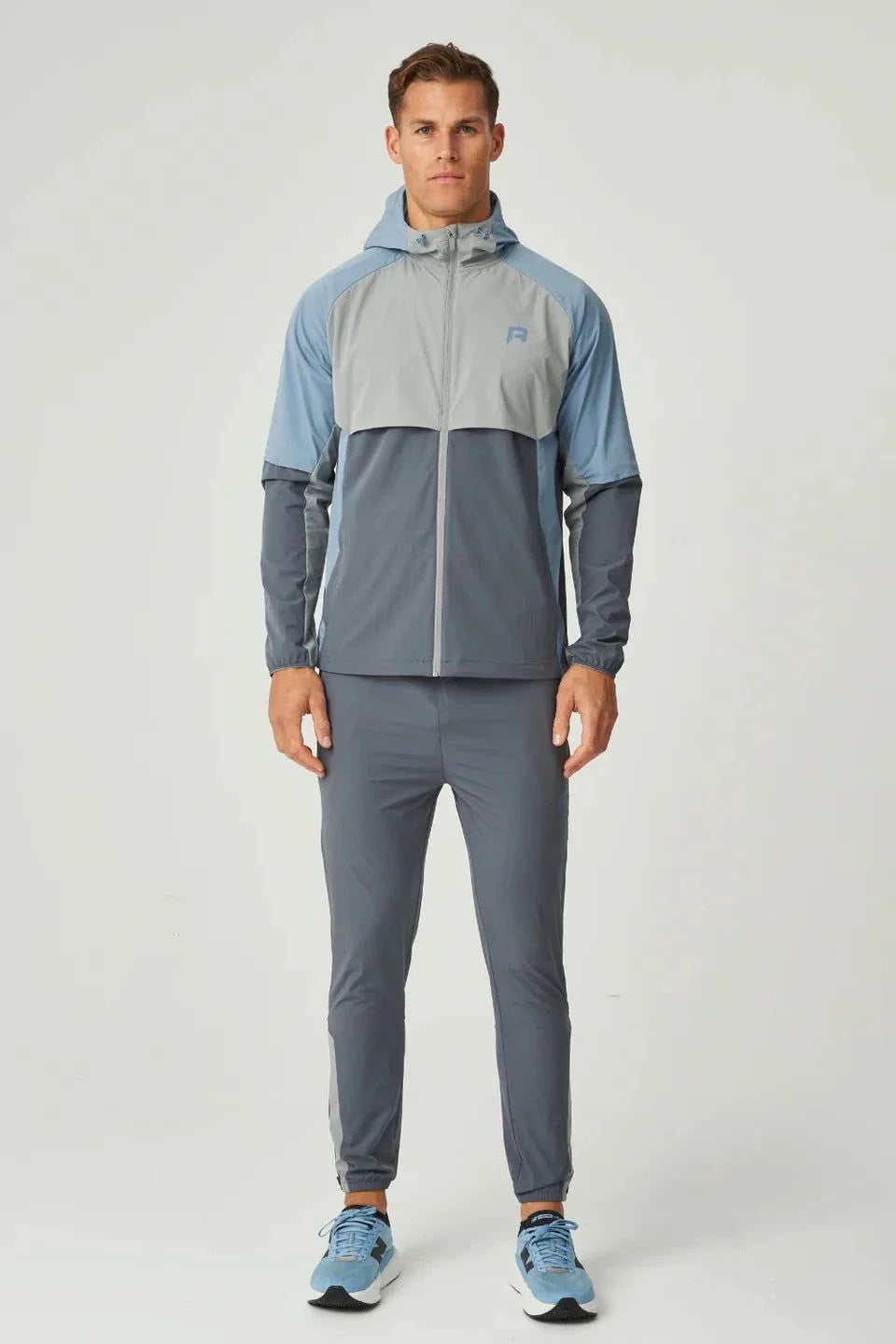 Men's Reprimo Vortex Windbreaker in dusky blue with ergonomic fit and reflective details