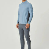 Man wearing dusky blue Reprimo Vortex Pants with ergonomic paneling and adjustable waistband.