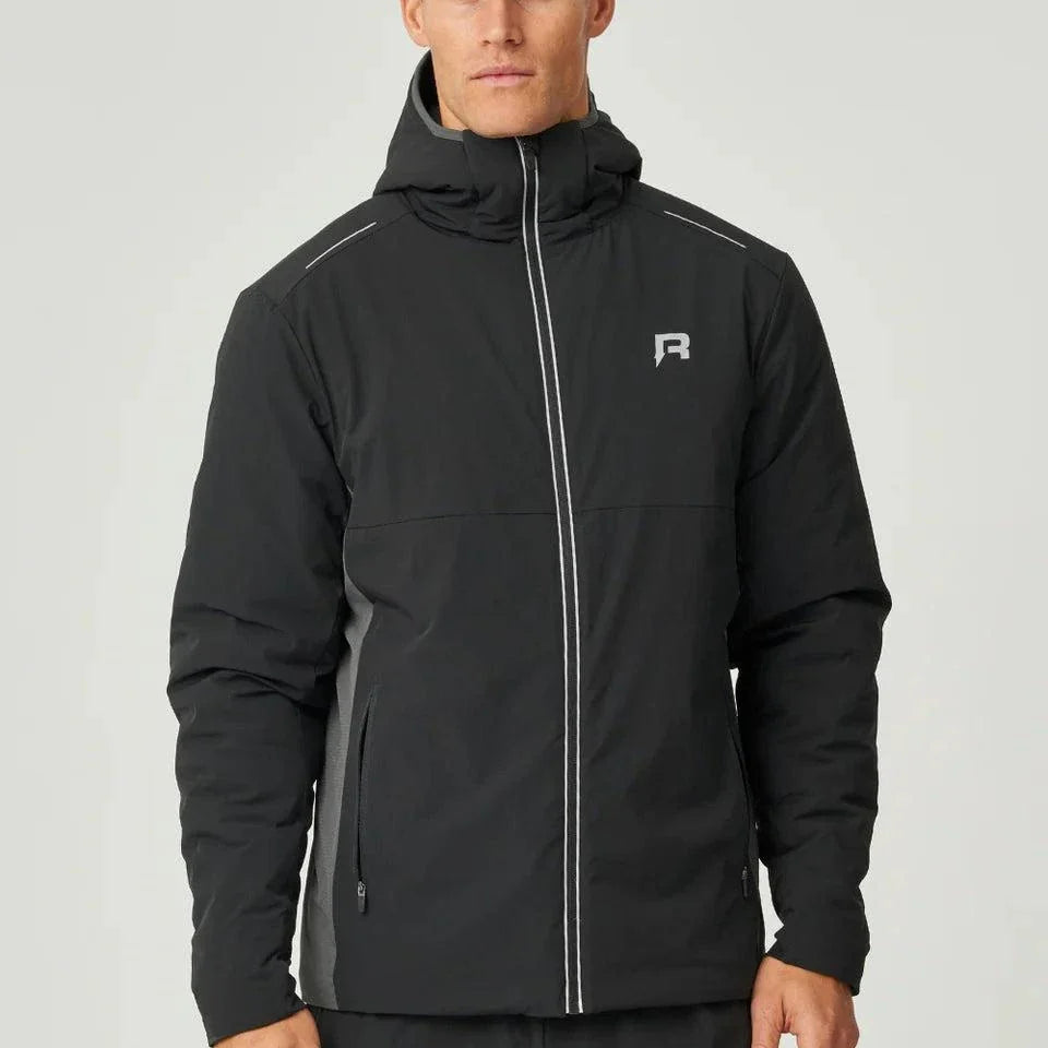 Man wearing black Reprimo Clima Jacket with zip pockets and hood, lightweight windbreaker for outdoor activities