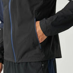 Close-up of Reprimo Nova Jacket in black and navy with zipper pocket and long sleeve detail
