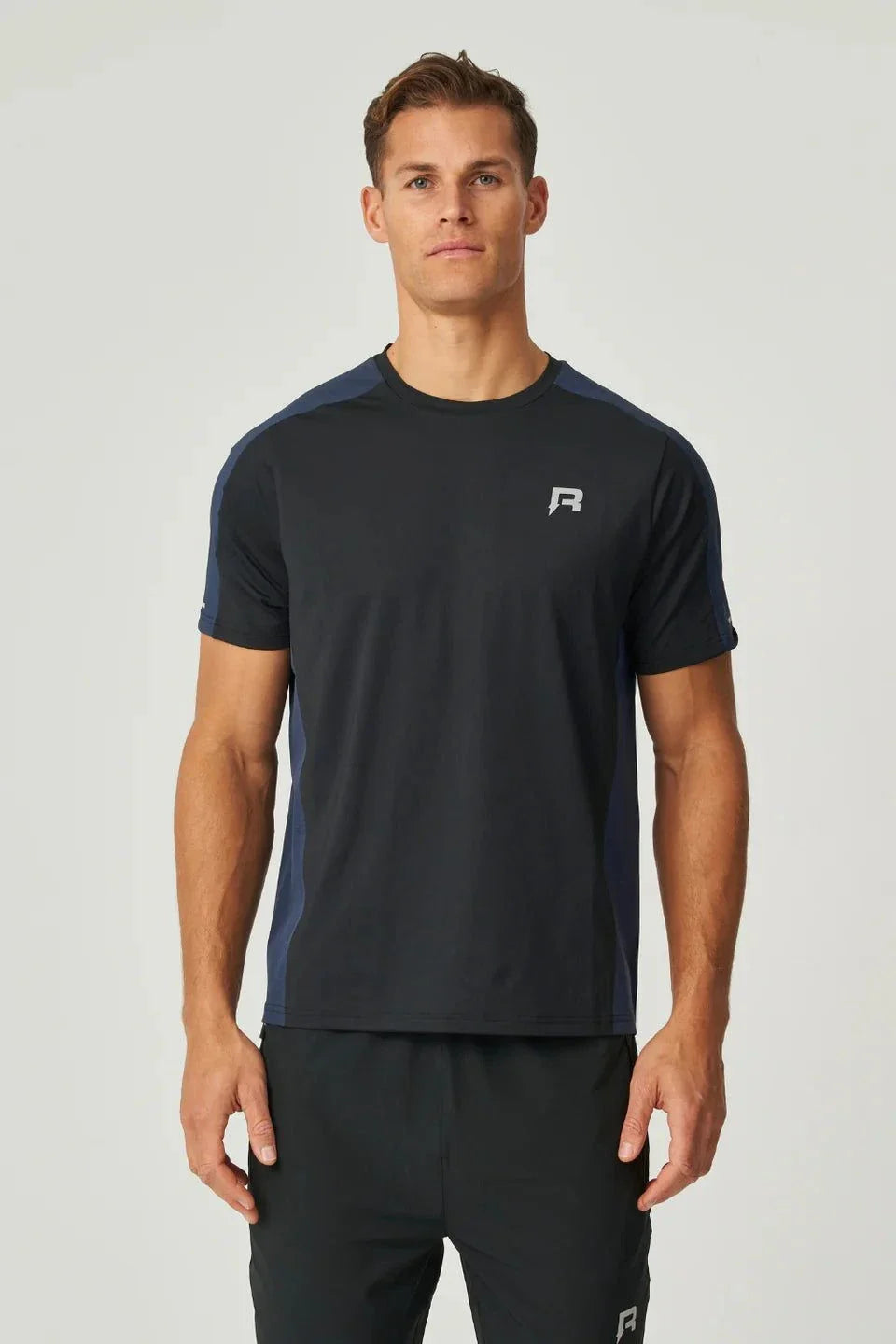 Reprimo Nova T-Shirt black and navy duo-tone design with heat-sealed seams and reflective details worn by male model