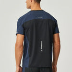 Back view of a man wearing a black and navy Reprimo Nova T-Shirt with reflective detailing and heat-sealed seams
