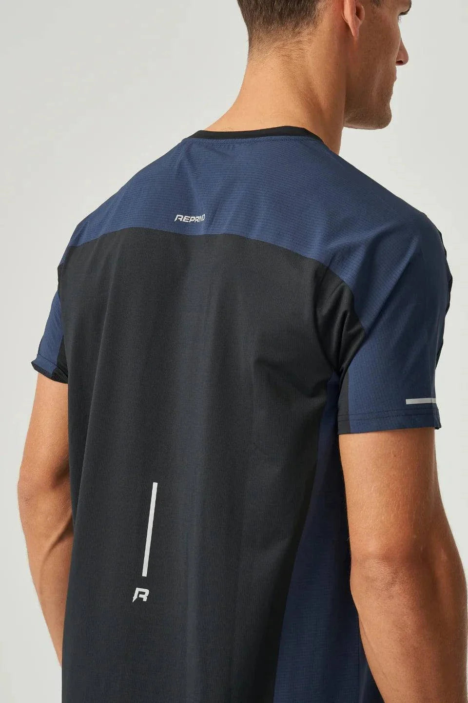 Back view of Reprimo Nova T-Shirt in black and navy with reflective detailing and heat-sealed seams.