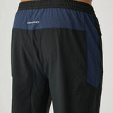Back view of Reprimo Nova Pants in black and navy with elastic waistband and reflective logo detail