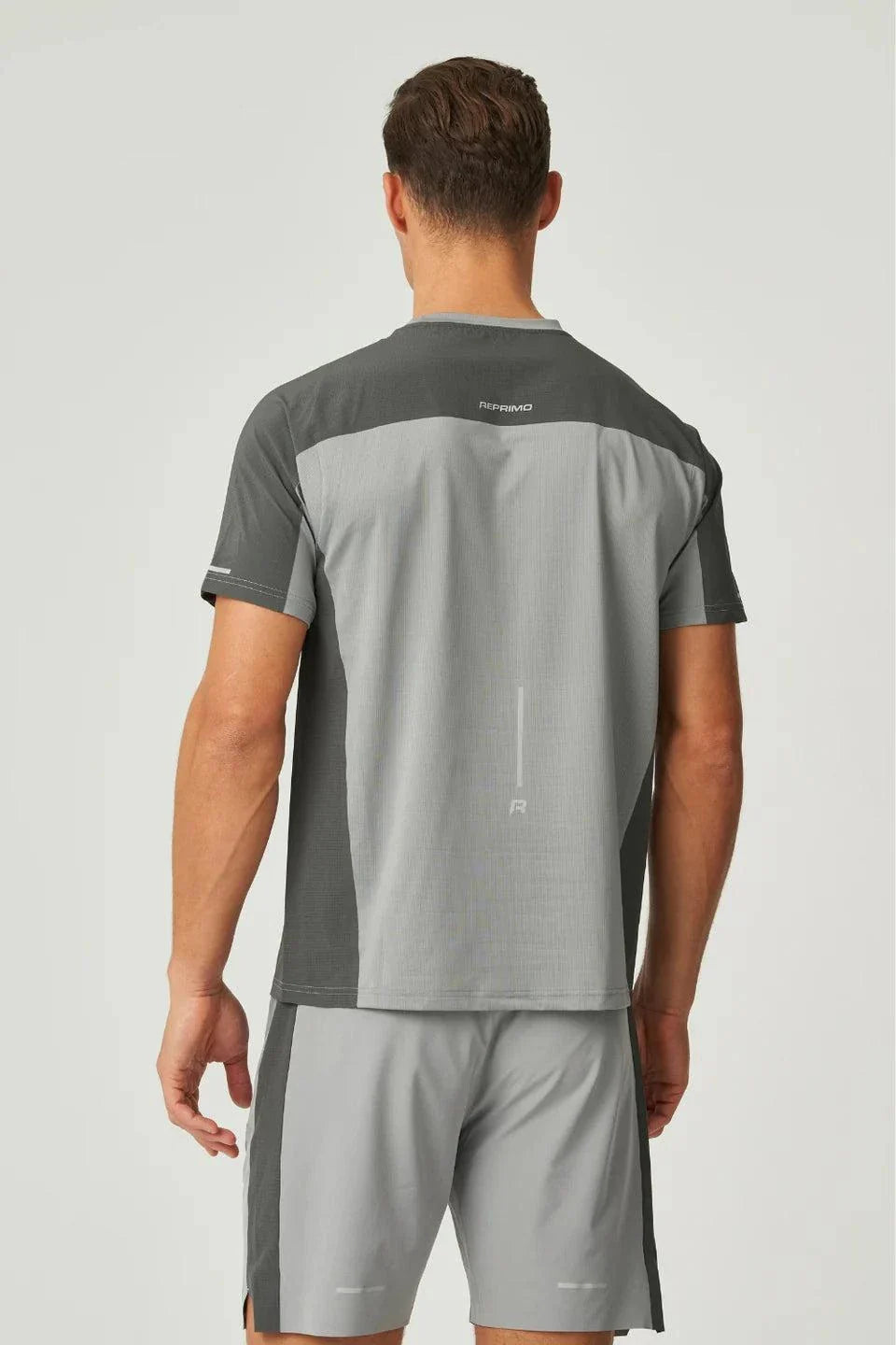 Back view of man wearing Reprimo Nova T-Shirt in slate and marble with duo-tone design and reflective detailing