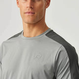 Male model wearing Reprimo Nova T-Shirt in slate and marble with duo-tone design, heat-sealed seams, and reflective detailing for athletic performance
