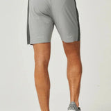 Back view of man wearing lightweight breathable Reprimo Nova Shorts in slate and marble colors for active performance