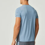 Rear view of man wearing dusky blue Reprimo Vortex T-Shirt with ergonomic panels and lightweight fabric