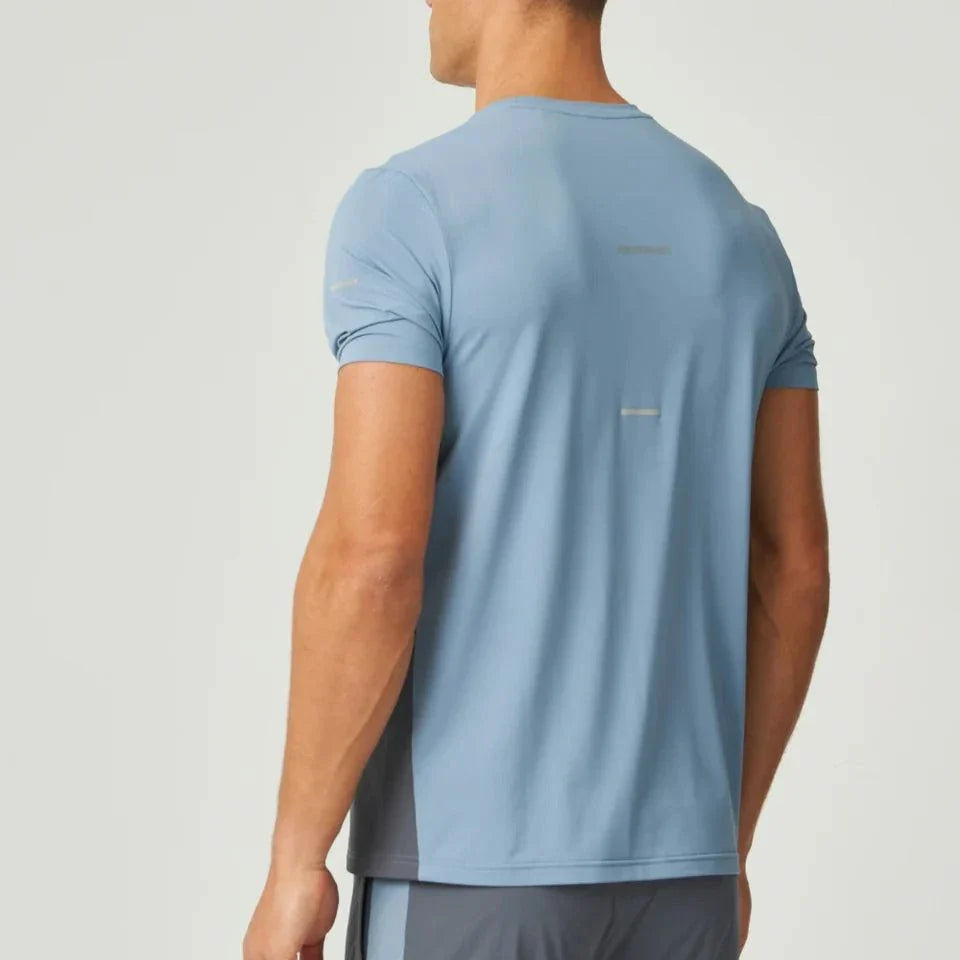 Rear view of man wearing dusky blue Reprimo Vortex T-Shirt with ergonomic panels and lightweight fabric