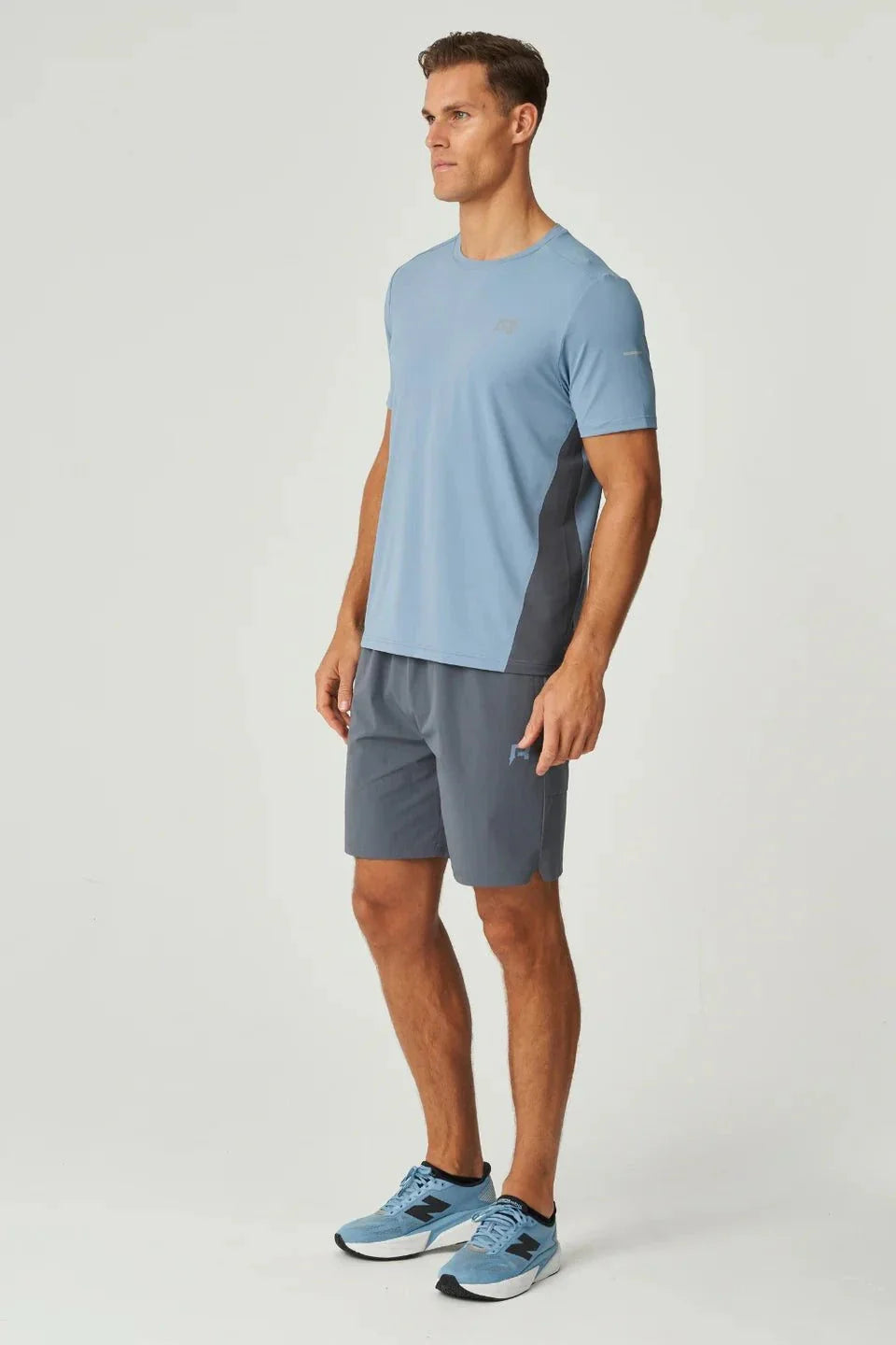 Man wearing dusky blue Reprimo Vortex Shorts with ergonomic panels and adjustable waistband.