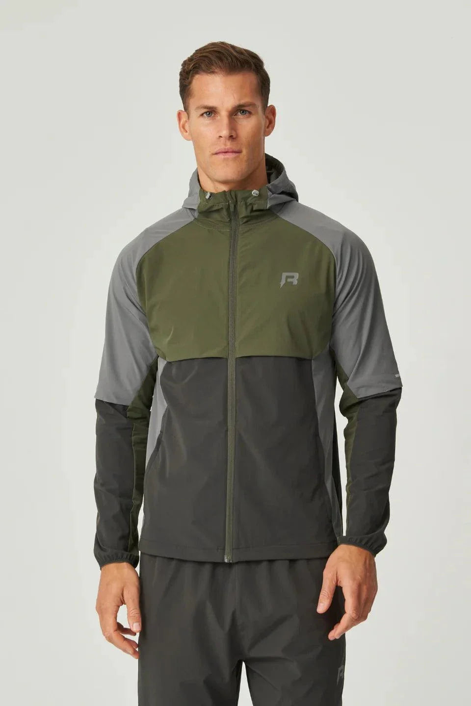 Reprimo Vortex Windbreaker olive and dark grey lightweight wind-resistant jacket with reflective details and ergonomic fit on male model
