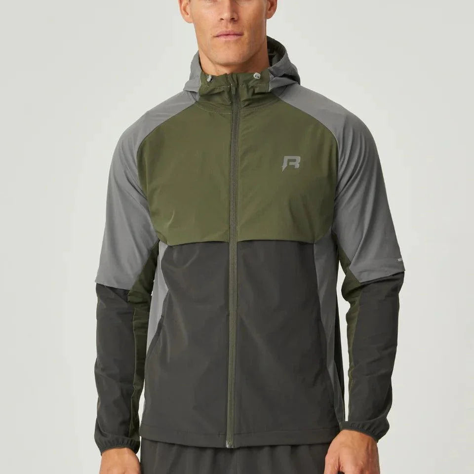 Reprimo Vortex Windbreaker olive and dark grey lightweight wind-resistant jacket with reflective details and ergonomic fit on male model