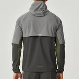 Back view of man wearing Reprimo Vortex Windbreaker in olive and dark grey with ergonomic fit and reflective details