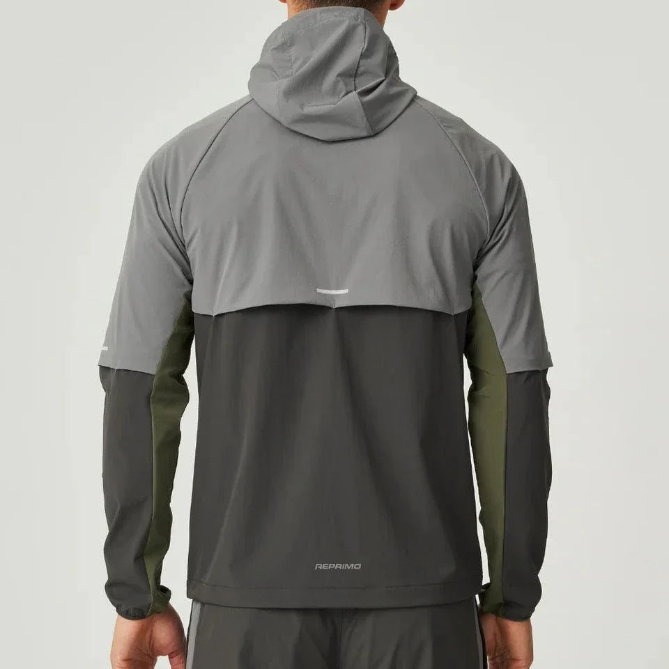 Back view of man wearing Reprimo Vortex Windbreaker in olive and dark grey with ergonomic fit and reflective details