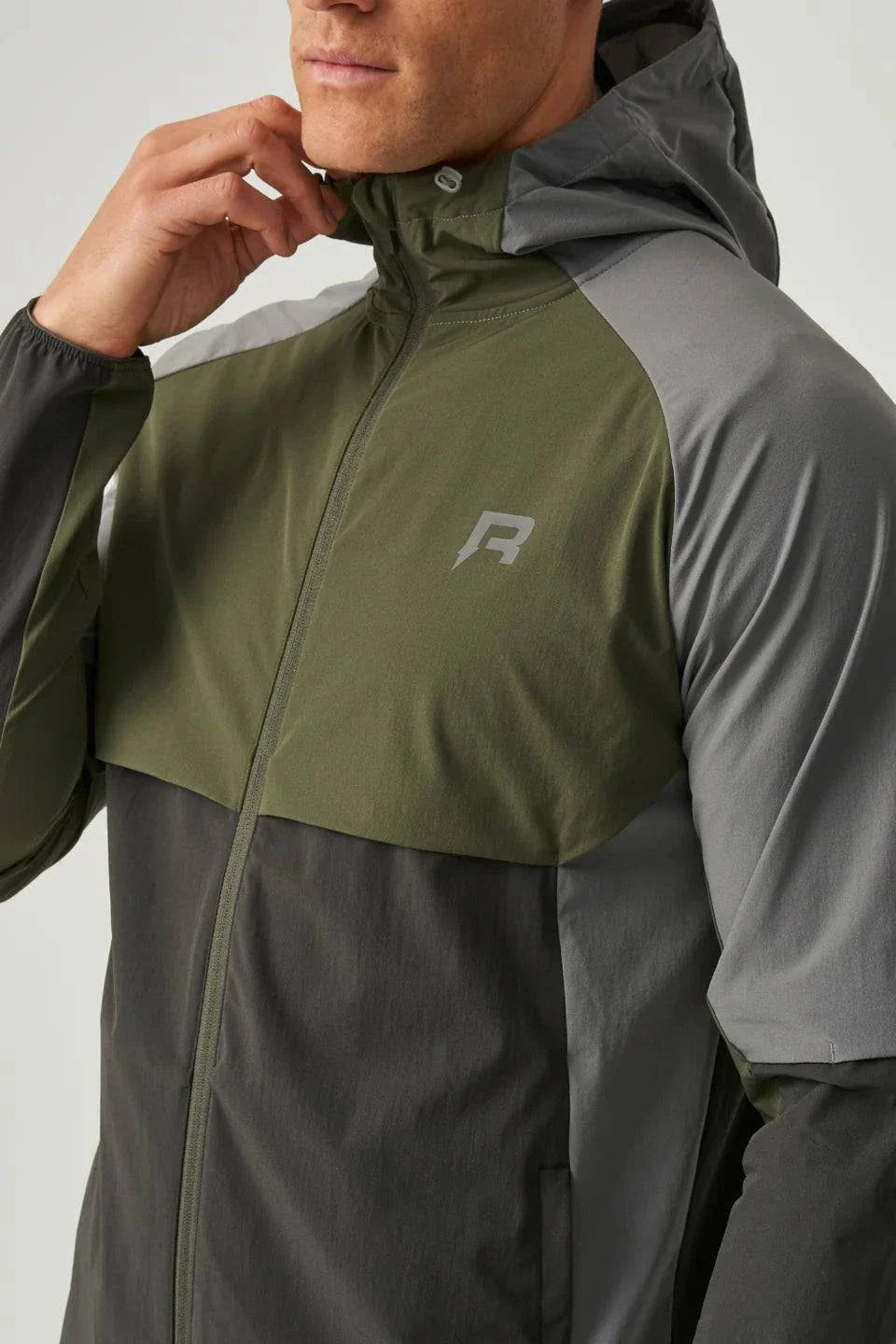 Reprimo Vortex Windbreaker in olive and dark grey with ergonomic design and reflective details