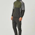 Man wearing olive and dark grey Reprimo Vortex Windbreaker with ergonomic design and reflective details