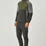Man wearing olive and dark grey Reprimo Vortex Windbreaker with ergonomic design and reflective details