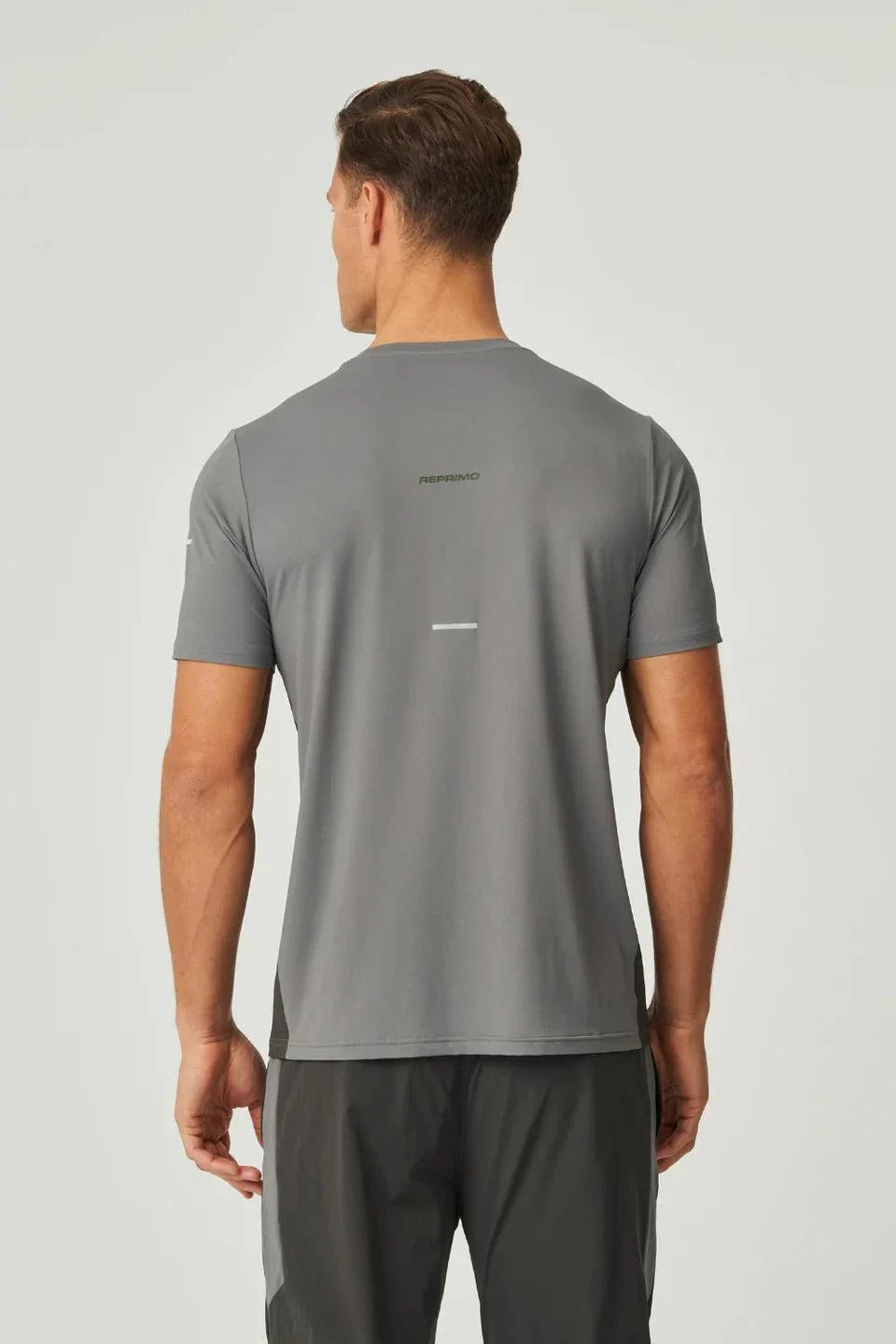 Back view of man wearing olive and dark grey Reprimo Vortex T-Shirt with ergonomic shaping and lightweight performance fabric