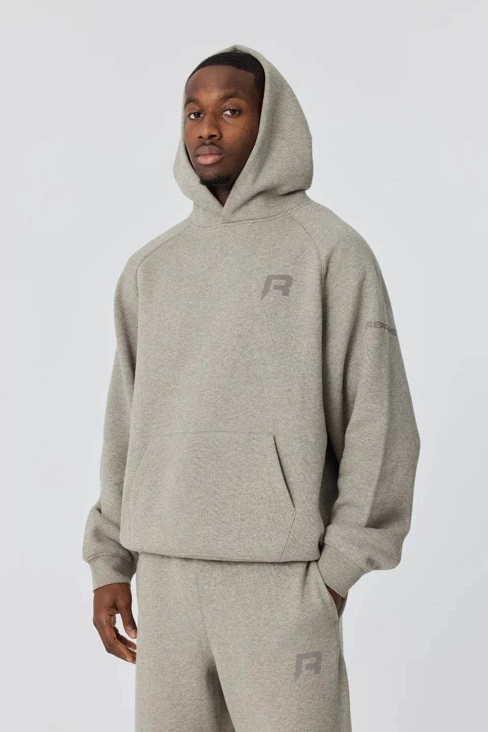 Grey Reprimo Collective Hoodie with brushed-back jersey fabric and reflective details worn by male model