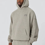 Grey Reprimo Collective Hoodie with brushed-back jersey fabric and reflective details worn by male model