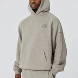Grey Reprimo Collective Hoodie with brushed-back jersey fabric and reflective details worn by male model