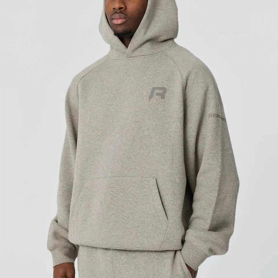 Grey Reprimo Collective Hoodie with brushed-back jersey fabric and reflective details worn by male model
