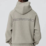 Back view of grey Reprimo Collective Hoodie with reflective branding on brushed-back jersey fabric