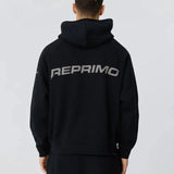 Rear view of a man wearing black Reprimo Collective Hoodie with reflective logo and ergonomic fit