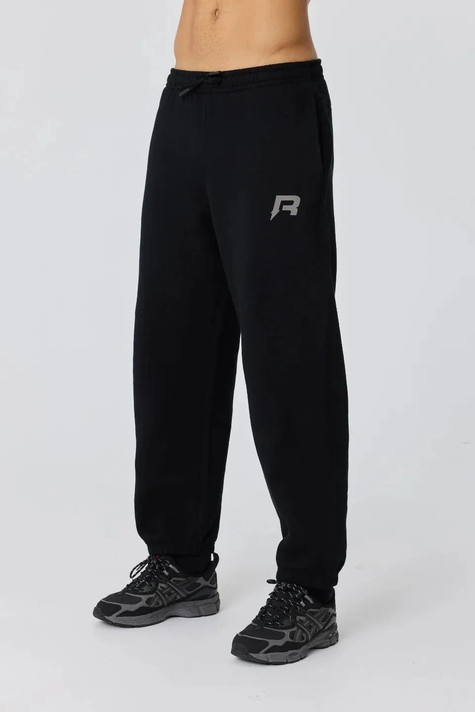 Black Reprimo Collective Joggers with reflective logo, adjustable waistband, and ergonomic fit for comfort and performance