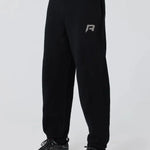 Black Reprimo Collective Joggers with reflective logo, adjustable waistband, and ergonomic fit for comfort and performance