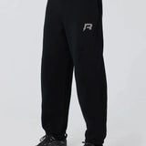 Black Reprimo Collective Joggers with reflective logo, adjustable waistband, and ergonomic fit for comfort and performance