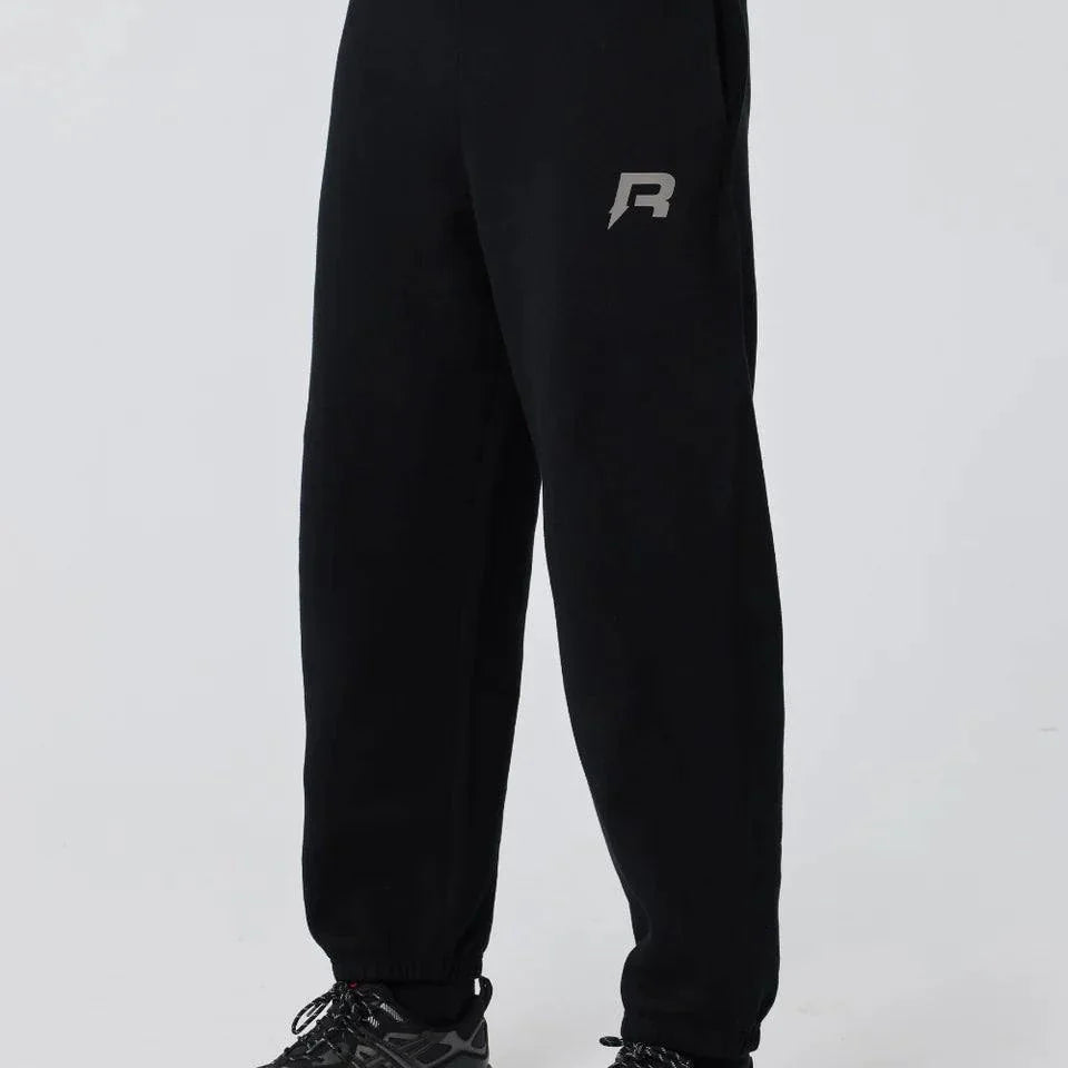 Black Reprimo Collective Joggers with reflective logo, adjustable waistband, and ergonomic fit for comfort and performance