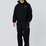 Man wearing black Reprimo Collective Joggers with adjustable waistband and reflective branding.