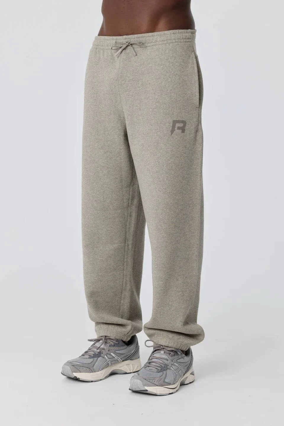 Grey Reprimo Collective Joggers with brushed-back jersey fabric, ergonomic fit, adjustable waistband, and reflective branding details.