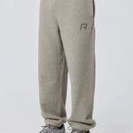 Grey Reprimo Collective Joggers with brushed-back jersey fabric, ergonomic fit, adjustable waistband, and reflective branding details.