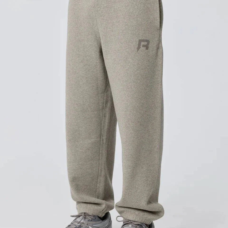 Grey Reprimo Collective Joggers with brushed-back jersey fabric, ergonomic fit, adjustable waistband, and reflective branding details.