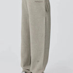 Side view of person wearing grey Reprimo Collective Joggers with adjustable waistband and reflective branding