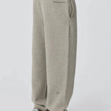 Side view of person wearing grey Reprimo Collective Joggers with adjustable waistband and reflective branding