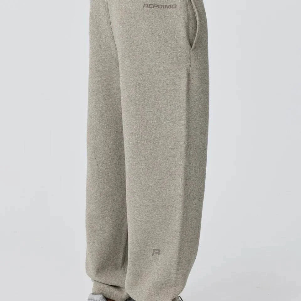 Side view of person wearing grey Reprimo Collective Joggers with adjustable waistband and reflective branding