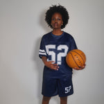 Woman wearing navy blue Five Questions Mesh Football Jersey holding a basketball