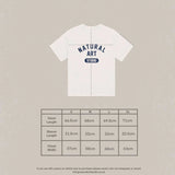 White Natural Art Studio Varsity Tee with navy screen print logo, boxy fit, oversized drop shoulder, made of 100% cotton, 350 GSM.