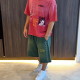 Green Suavo World studded sweat shorts with rhinestone diamond detailing and orange logo