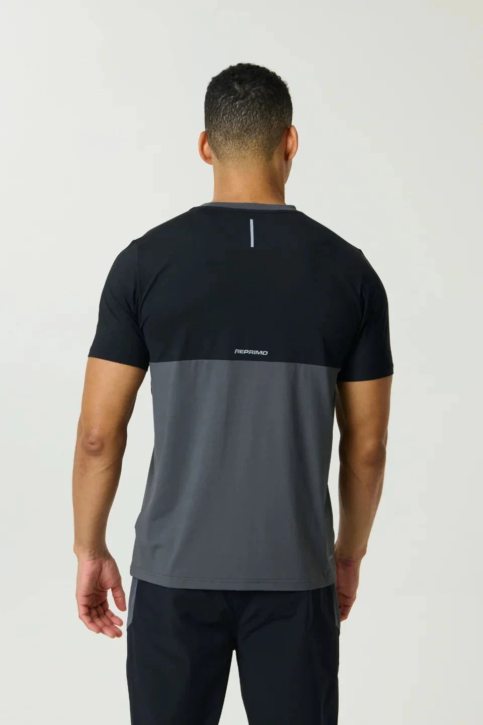 Reprimo Flight T-Shirt in Slate and Obsidian with athletic fit, lightweight breathable fabric, two-color block design, and reflective strips for visibility