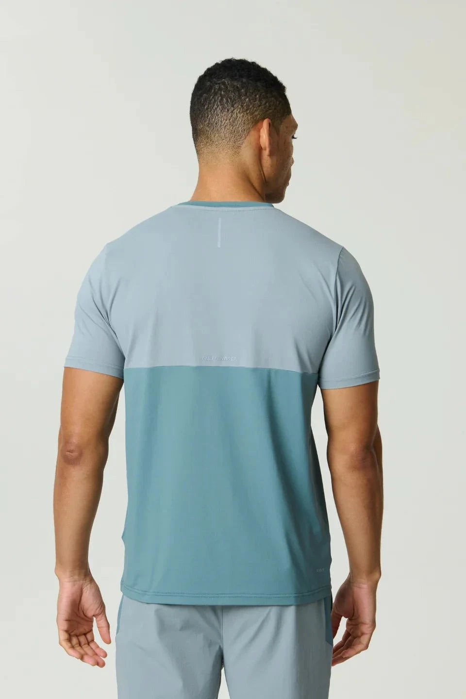 Reprimo Flight T-Shirt in Tide Marble color with lightweight, breathable fabric and reflective strips for athletic performance