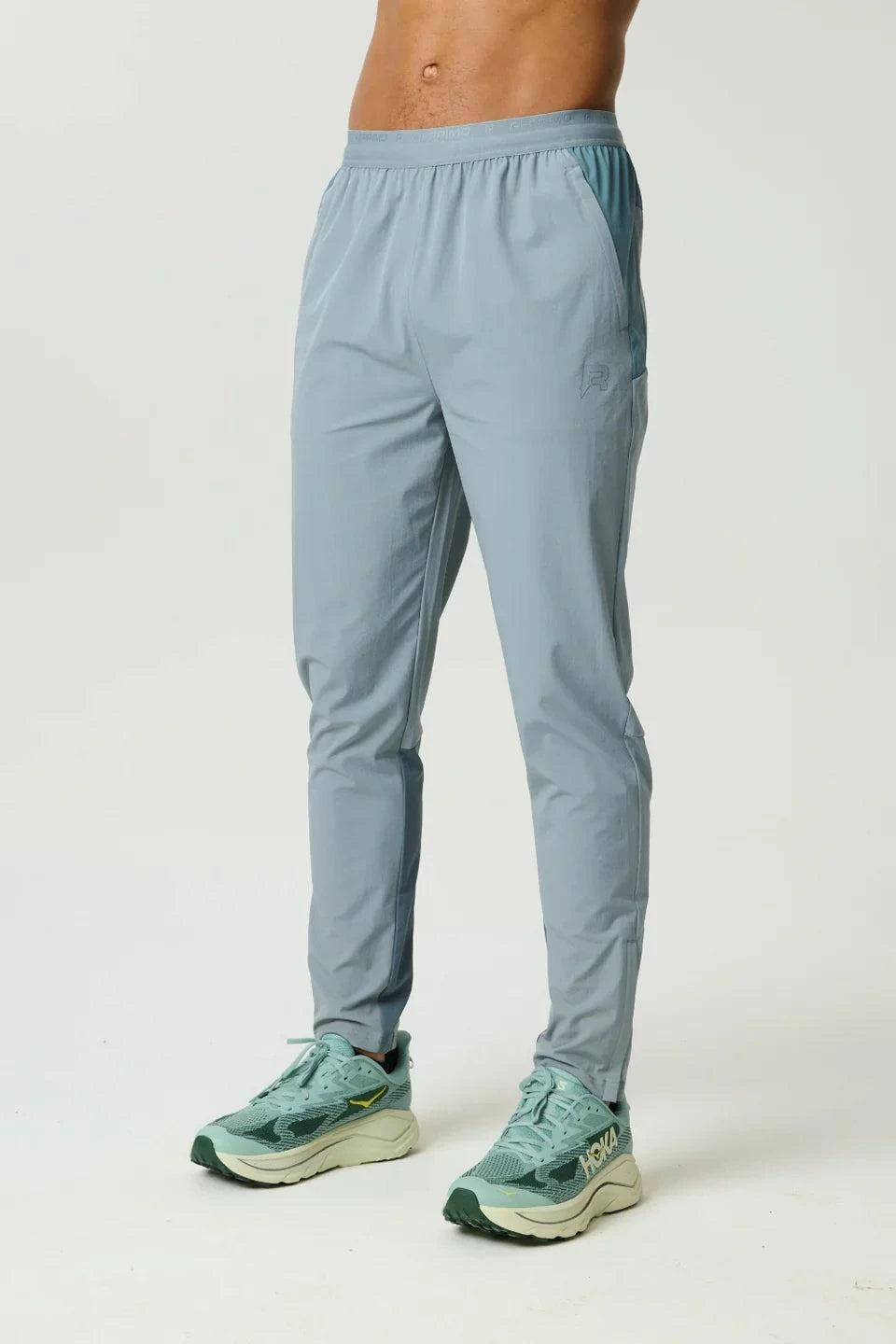 Reprimo Flight Pant in Tide Marble color with functional pockets and reflective strips for enhanced visibility and comfort during workouts