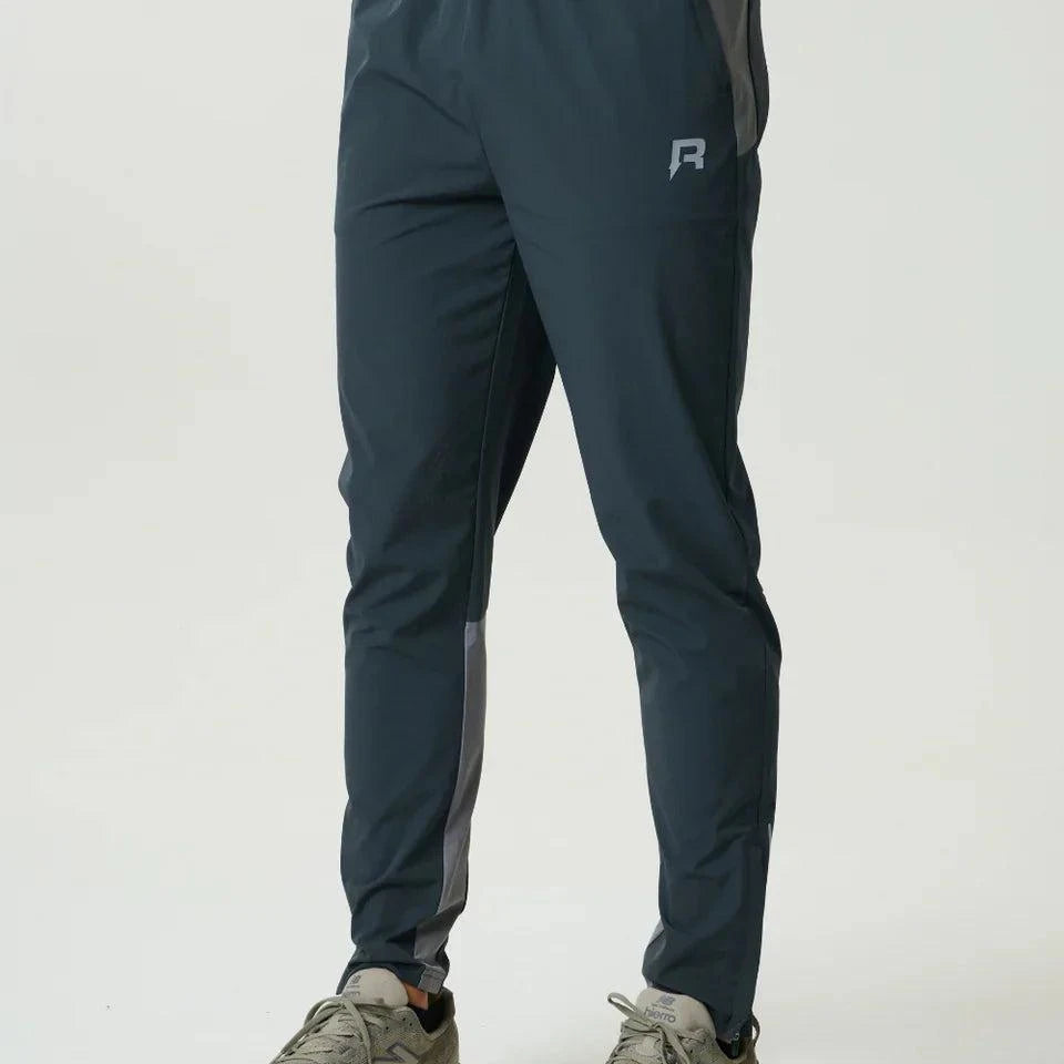 Reprimo Flight Pant in Gargoyle Ash Green with functional pockets, reflective strips, and breathable fabric for athletic performance