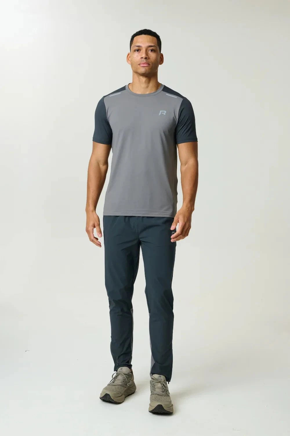 Reprimo Flight Pant in ash green with functional pockets and reflective strips for athletic performance and comfort