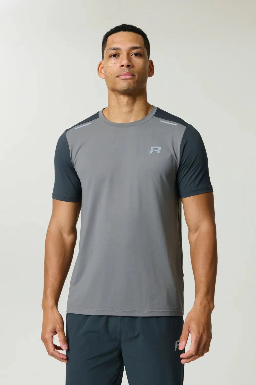Reprimo Flight T-Shirt in ash green with lightweight, breathable fabric and reflective strips for athletic performance and visibility